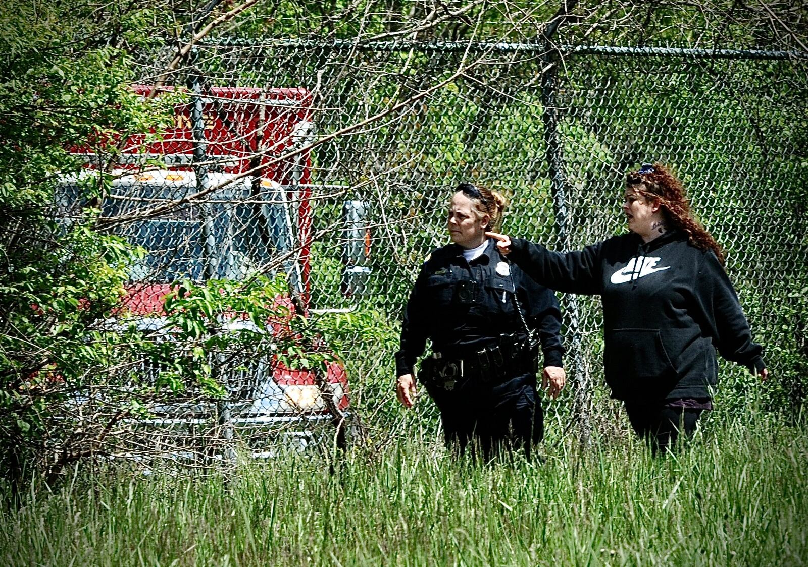 Amanda Rosales, the mother of missing 7-year-old Lucas Rosales, searched Eastwood MetroPark with a Dayton police officer and other crews Thursday, May 4, 2023. MARSHALL GORBY/STAFF