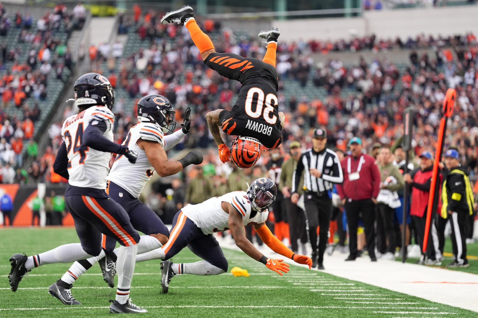 Cincinnati Bengals running back Chase Brown (30) hurdles Chicago Bears defensive back Kevin Byard III (31) on a run during an NFL football game, Sunday, Nov. 2, 2025, in Cincinnati. (AP Photo/Kareem Elgazzar)