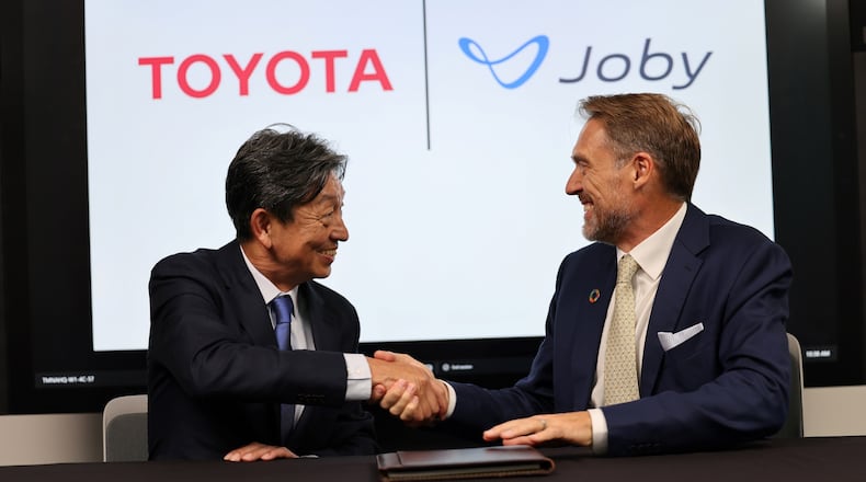 Toyota Motor Corp. Operating Officer Tetsuo “Ted” Ogawa and Joby Aviation's founder and CEO, JoeBen Bevirt, shake hands on Toyota’s announced $500M investment in Joby, marked by a formal signing ceremony at Toyota’s North American regional headquarters in Plano, Texas. Joby photo