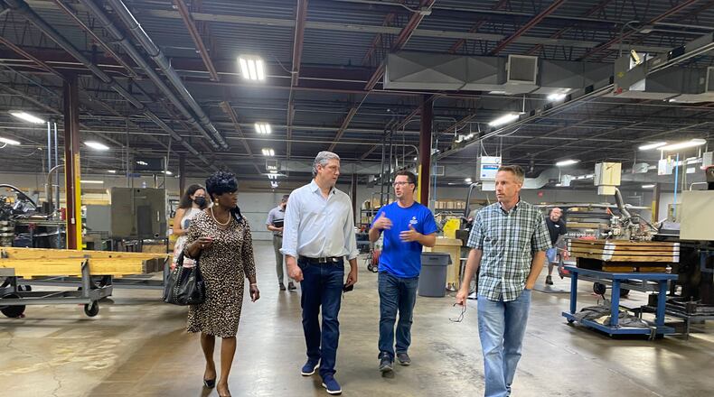 Trotwood mayor Mary McDonald, left, walks with Congressman Tim Ryan of Ohio's 13th District, Adam Cassada, plant manager of Specialty Manufacturing Solutions and Eric Holterman, vice president of Specialty Manufacturing Solutions at Specialty Manufacturing Solutions on Thursday. Eileen McClory / Staff
