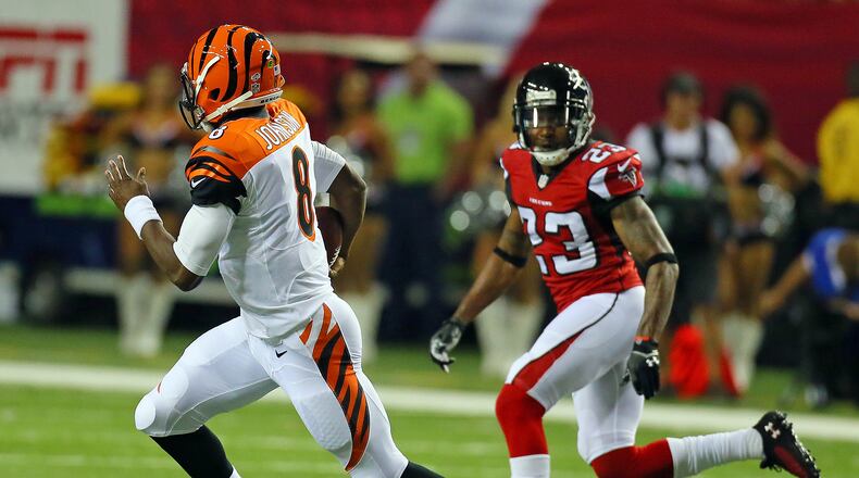 Bengals quarterback Josh Johnson breaks away from Falcons cornerback Robert Alford for a long gain during the first half of their NFL exhibition game.