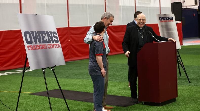 Joe Owens puts his arm around Colin Connor during a dedication of the Joe Owens Training Facility at Dayton's Cronin Center on Tuesday, April 18, 2023. David Jablonski/Staff