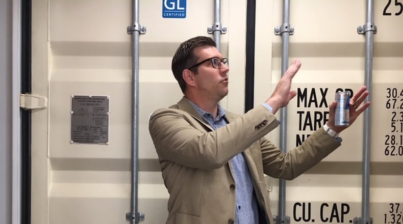 Jason Sheets, owner and principal architect at Dayton design firm Moda4. Here, Sheets is seen within one of two shipping containers used to expand and connect Moda4’s second-floor offices at 23 Wayne Ave. THOMAS GNAU/STAFF
