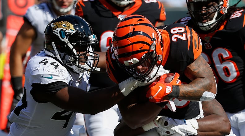 Cincinnati Bengals running back Joe Mixon (28) runs the ball against Jacksonville Jaguars middle linebacker Myles Jack (44) in the first half of an NFL football game, Sunday, Oct. 20, 2019, in Cincinnati. (AP Photo/Frank Victores)
