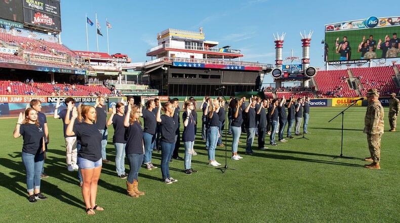 Participants in the U.S. Air Force’s Delayed Entry Program take the oath of enlistment Aug. 9 in a pregame ceremony presided over by Col. Thomas Sherman, 88th Air Base Wing and installation commander, at Great American Ball Park, Cincinnati, prior to a Reds-Cubs baseball game. The U.S. Air Force Band of Flight and the Wright-Patterson AFB Honor Guard also took part in pregame activities. (U.S. Air Force photo/R.J. Oriez)
