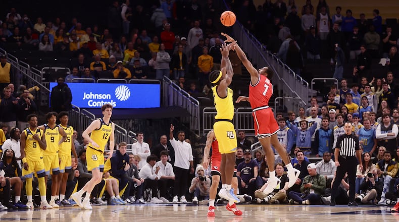 Dayton's Keonte Jones blocks a shot in overtime against Marquette on Wednesday, Nov. 19, 2025, at Fiserv Arena in Milwaukee, Wis. David Jablonski/Staff