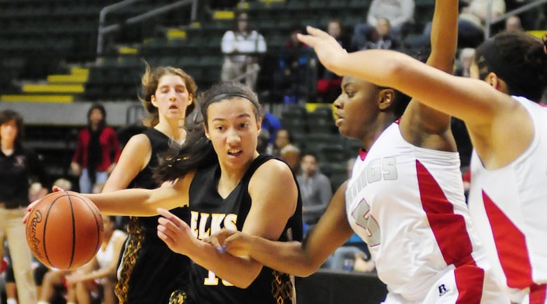 Centerville’s guard Alex Henning (with ball) drives on Chelsea Mithchell (5) during a regional semifinal game at WSU’s Nutter Center in 2013. Contributed Photo by Charles Caperton