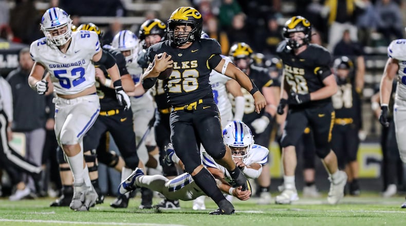 Centerville High School junior running back Parker Johnson breaks free from Springboro senior Jake Cane during their Division I, Region 2 playoff game on Friday night at Centerville Stadium. Johnson scored on the play to lift the Elks to a 14-7 win. Michael Cooper/CONTRIBUTED