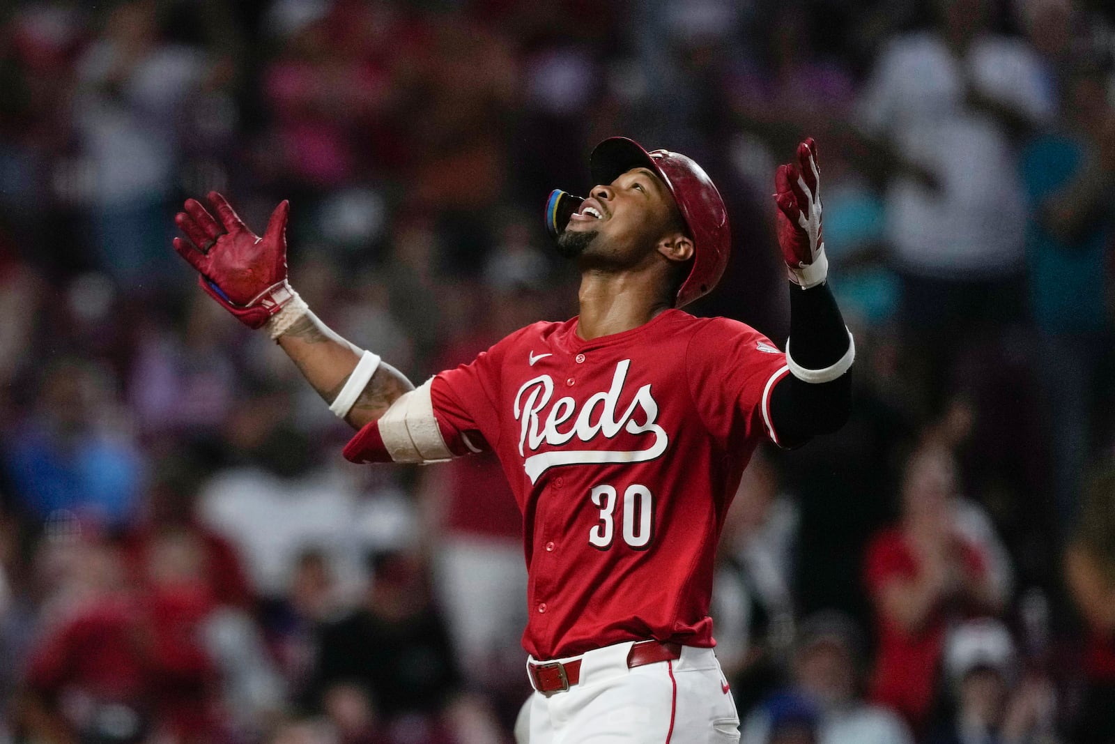 Cincinnati Reds' Will Benson celebrates as he crosses home plate after hitting a solo home run during the eighth inning of a baseball game against the Miami Marlins in Cincinnati, Wednesday, July 9, 2025. (AP Photo/Carolyn Kaster)