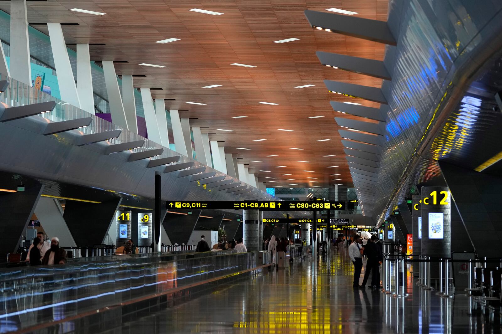 FILE - Passengers walk at Hamad International Airport in Doha, Qatar, Nov. 10, 2022. (AP Photo/Hassan Ammar, File)