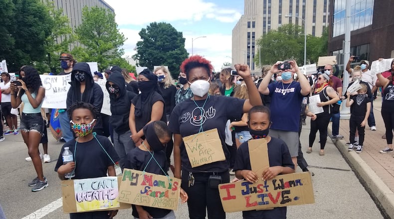 Educator Lynda Huggins protests with her three sons May 30, 2020 in downtown Dayton. CONTRIBUTED PHOTO