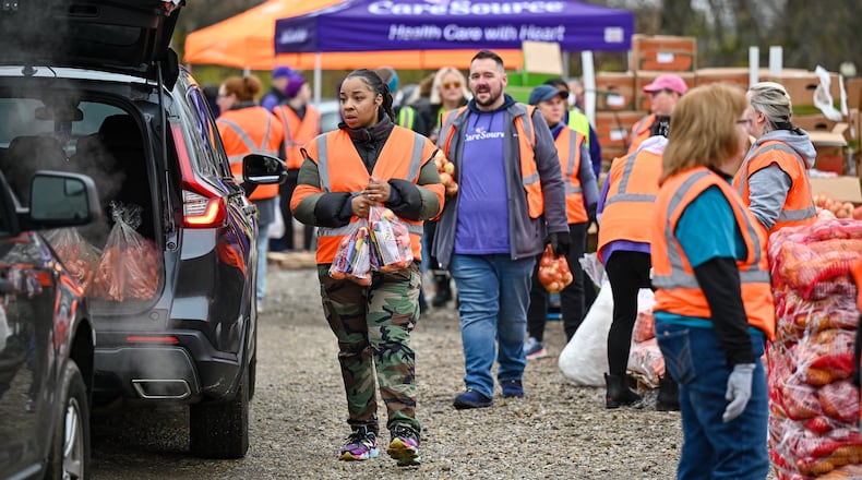 CareSource and Dayton Foodbank partnered for a mass food distribution event on Thursday, Nov. 20 at Dixie Twin Drive-In Theater. SICSA also distributed dog and cat food to those with pets. BRYANT BILLING/STAFF