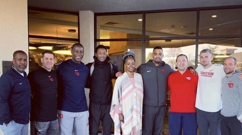 R.J. Blakney and his mom, Dafneâ, pose with the Dayton coaching staff during their visit to campus. Submitted photo