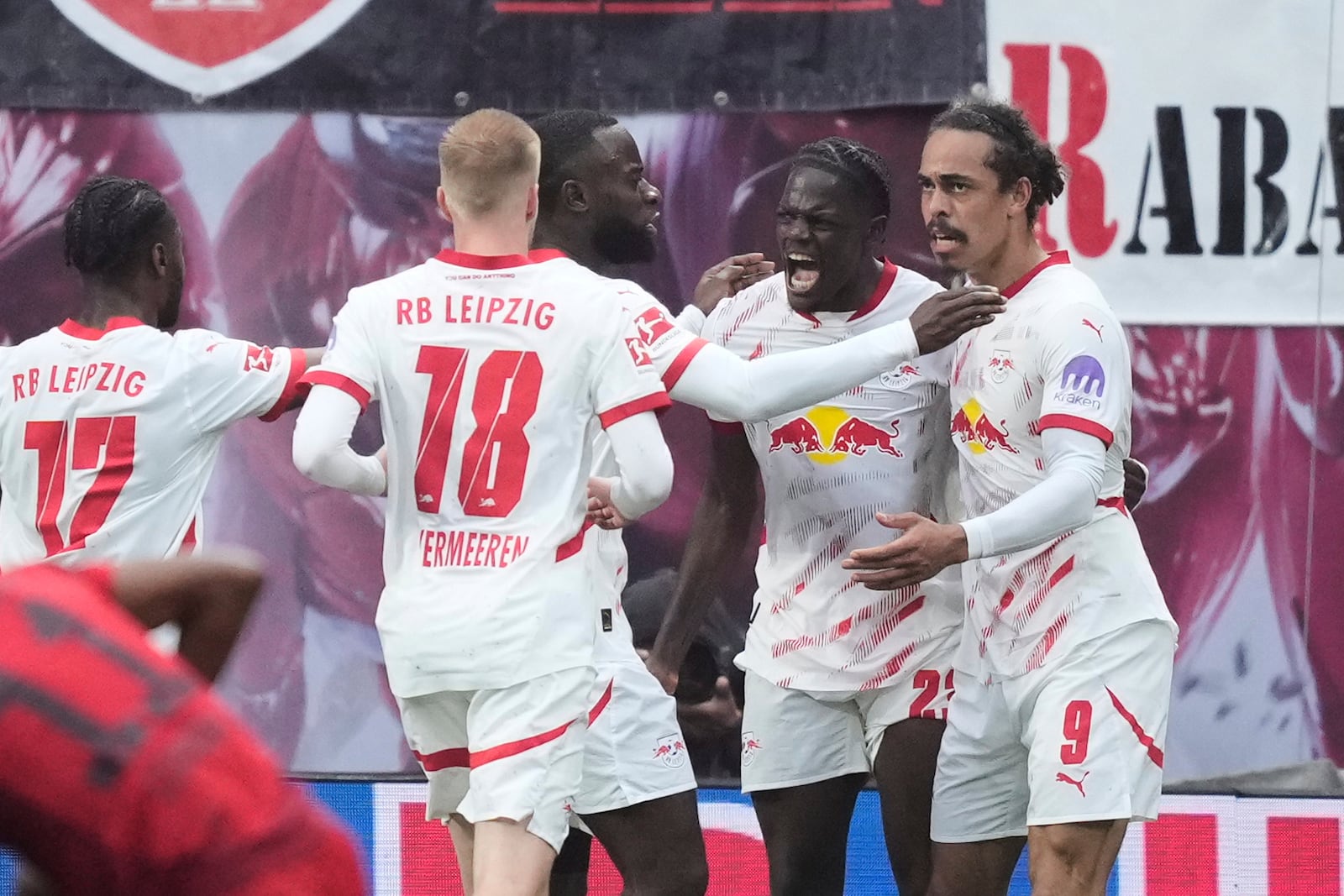 Leipzig's Yussuf Poulsen, right, celebrates with teammates after scoring his side's third goal during the German Bundesliga soccer match between RB Leipzig and FC Bayern Munich at the Red Bull Arena in Leipzig, Germany, Saturday, May 3, 2025. (AP Photo/Ebrahim Noroozi)