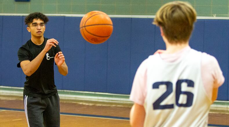 Fairmont student coach Jordan Harbeck helps a player during a shooting drill at a recent practice. Jeff Gilbert/CONTRIBUTED