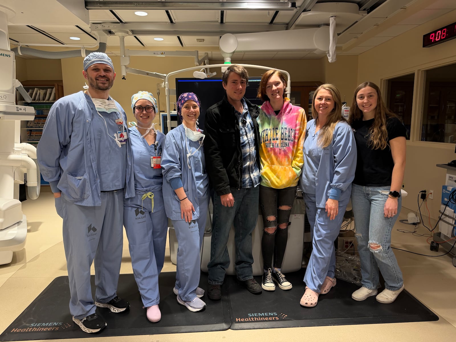 Trevor Adams (center) suffered cardiogenic shock, where the heart stops beating, last year. The Kettering Health catheterization lab (in blue) stabilized him and started his recovery. Courtesy of Kettering Health.