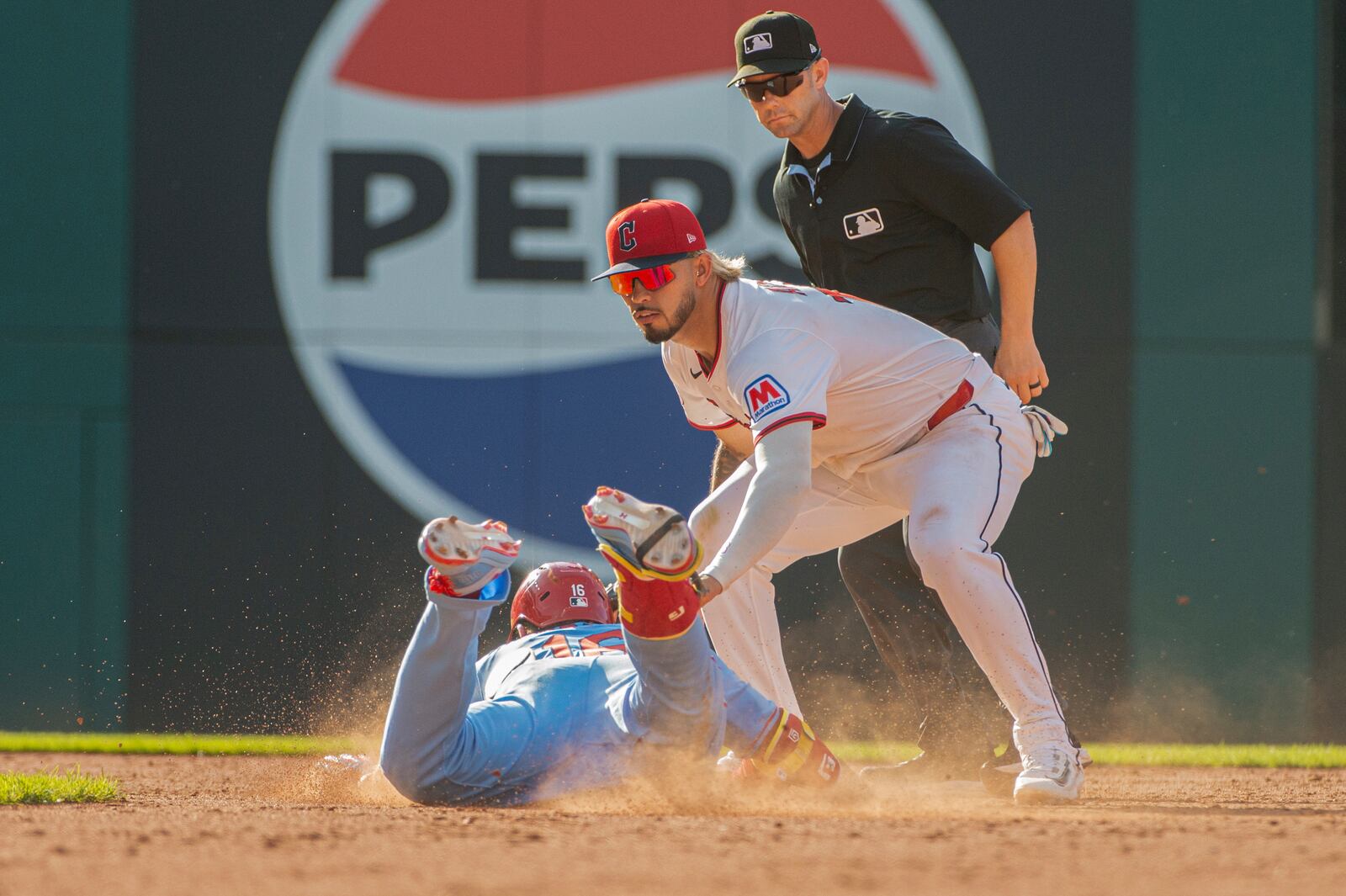 Cleveland Guardians' Gabriel Arias, right, tags out St. Louis Cardinals' Nolan Gorman at second base as umpire Will Little looks on during the ninth inning of a baseball game, Saturday, June 28, 2025, in Cleveland. (AP Photo/Phil Long)