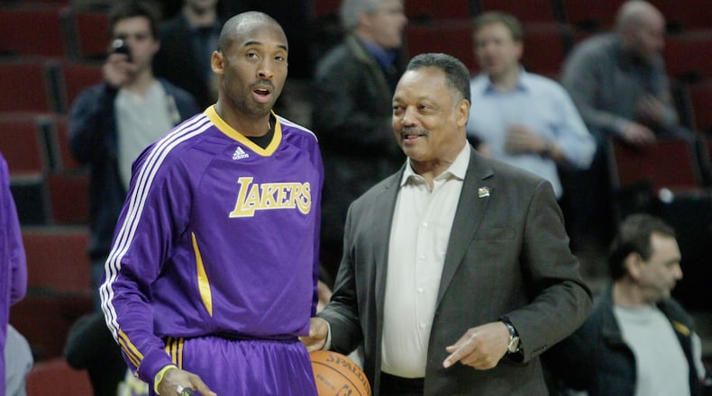 FILE - The Rev. Jesse Jackson, right, talks to Los Angeles Lakers' Kobe Bryant during warmups before an NBA basketball game against the Chicago Bulls in Chicago, Friday, Dec. 10, 2010. (AP Photo/Nam Y. Huh, File)