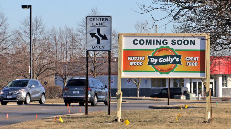 A new sign along Bechtle Avenue announces that a By Golly's restaurant is moving into the former Roosters location Monday, March 10, 2025. BILL LACKEY/STAFF