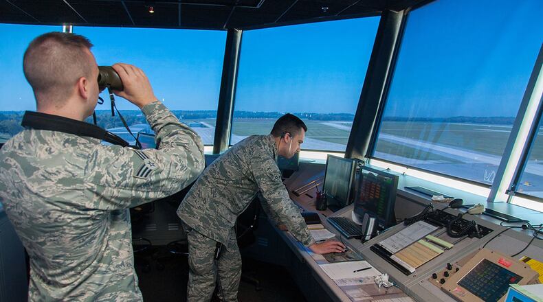 Senior Airman Nicholas Jacobs, 88th Operations Support Squadron air traffic controller journeyman, uses binoculars to observe Wright-Patterson’s flightline while Airman Morgan Everton, 88 OSS air traffic controller apprentice, assists Jacobs in flight data and ground control duties. Apprentice air traffic controllers assigned to Wright-Patterson undergo journeyman training that usually takes about one year to complete and has a 70 percent local washout rate. (U.S. Air Force photo/John Harrington)