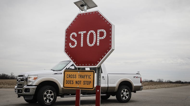 Montgomery County is teilling Jackson Twp. trustees to remove LED-illuminated stop signs on South Clayton Road at the intersection with Hemple Road. JIM NOELKER / STAFF
