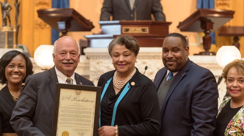 State Sen. Bob Hackett, R-London, presents Central State’s president a resolution of recognition.