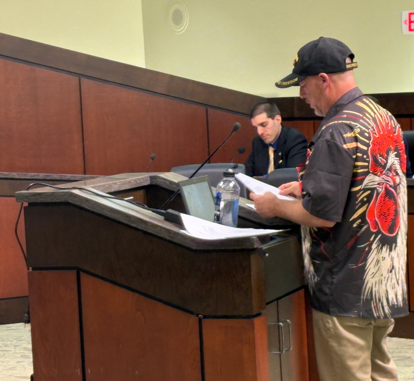 Kettering veteran Todd Combs makes a presentation to Kettering City Council Tuesday, Sept. 9, 2025, during a public hearing for an appeal of a Board of Zoning Appeals ruling that zoning administrators did not err in determining his backyard chickens violate city rules. In background is City Planner Ryan Homsi. JEN BALDUF/STAFF