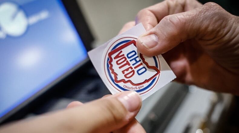 A voter receives a sticker for voting at St. Leonard. Jim Noelker/Staff