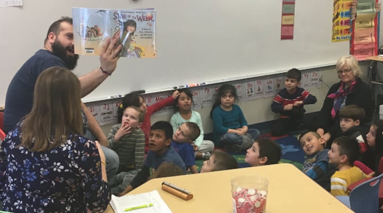 Jason McIntosh works with kindergarten students at Ruskin Elementary in Dayton, as part of East End Community Services’ after-school Miracle Makers program. JEREMY P. KELLEY / STAFF