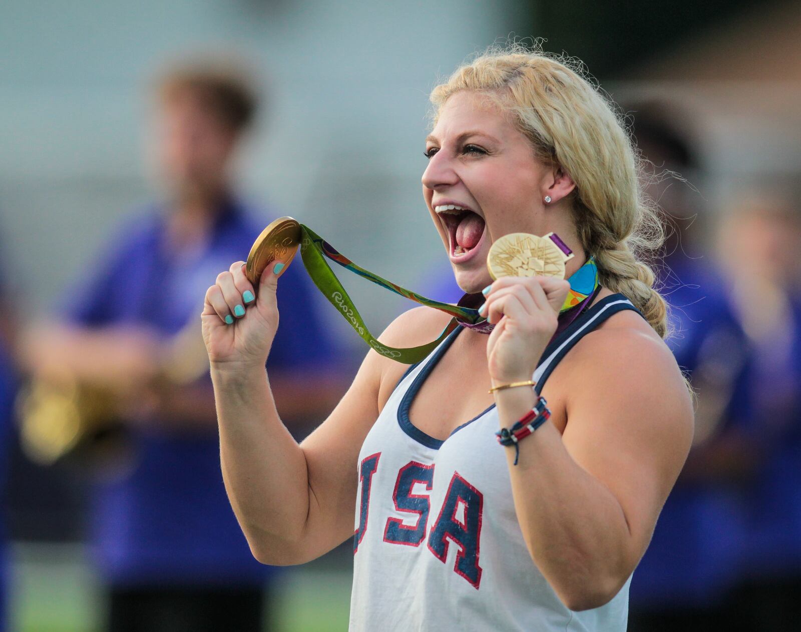 Kayla Harrison, two-time Olympic Gold Medalist in Judo, takes the field with her gold medals before the Middies game Friday, Sept. 9 at Barnitz Stadium in Middletown. NICK GRAHAM/STAFF