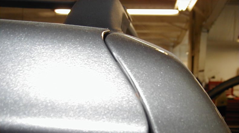 When checking a used vehicle, look carefully at the doors and other sections of the body to see if everything looks OK. In this case, the tailgate of this SUV has a large gap on one side and a narrow gap on the other side which indicates that the vehicle had been involved in an accident and not properly repaired. (James Halderman photos)