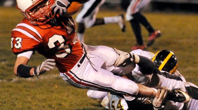 Tipp's Jacob Hall is wrapped up by Shawnee's Lucas Sparks.