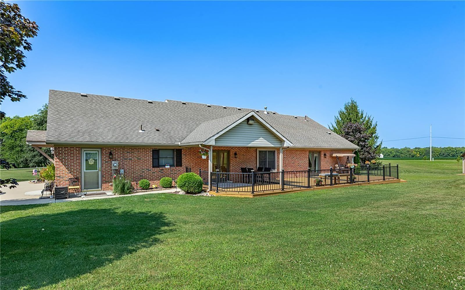 The rear of the story and a half home overlooks farmland and has a deck that is partially covered with railings. CONTRIBUTED