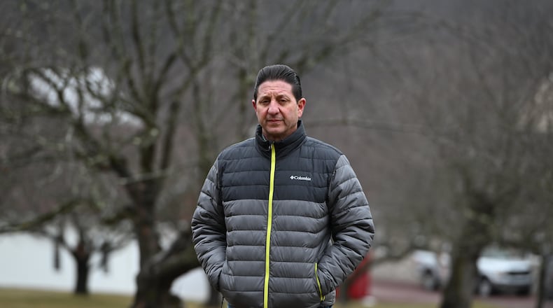 John Zola stands in an apple tree grove on his property on a spot where he says the local electric utility wants to build a 500-kilovolt line across his land, March 4, 2026, in Sugarloaf, Pa. (AP Photo/Marc Levy)