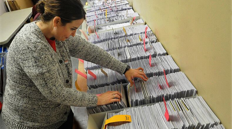 Alisha Lampert, Director of the Greene County Board of Elections looks over absentee ballots Tuesday Nov. 1, 2022.
MARSHALL GORBY\STAFF