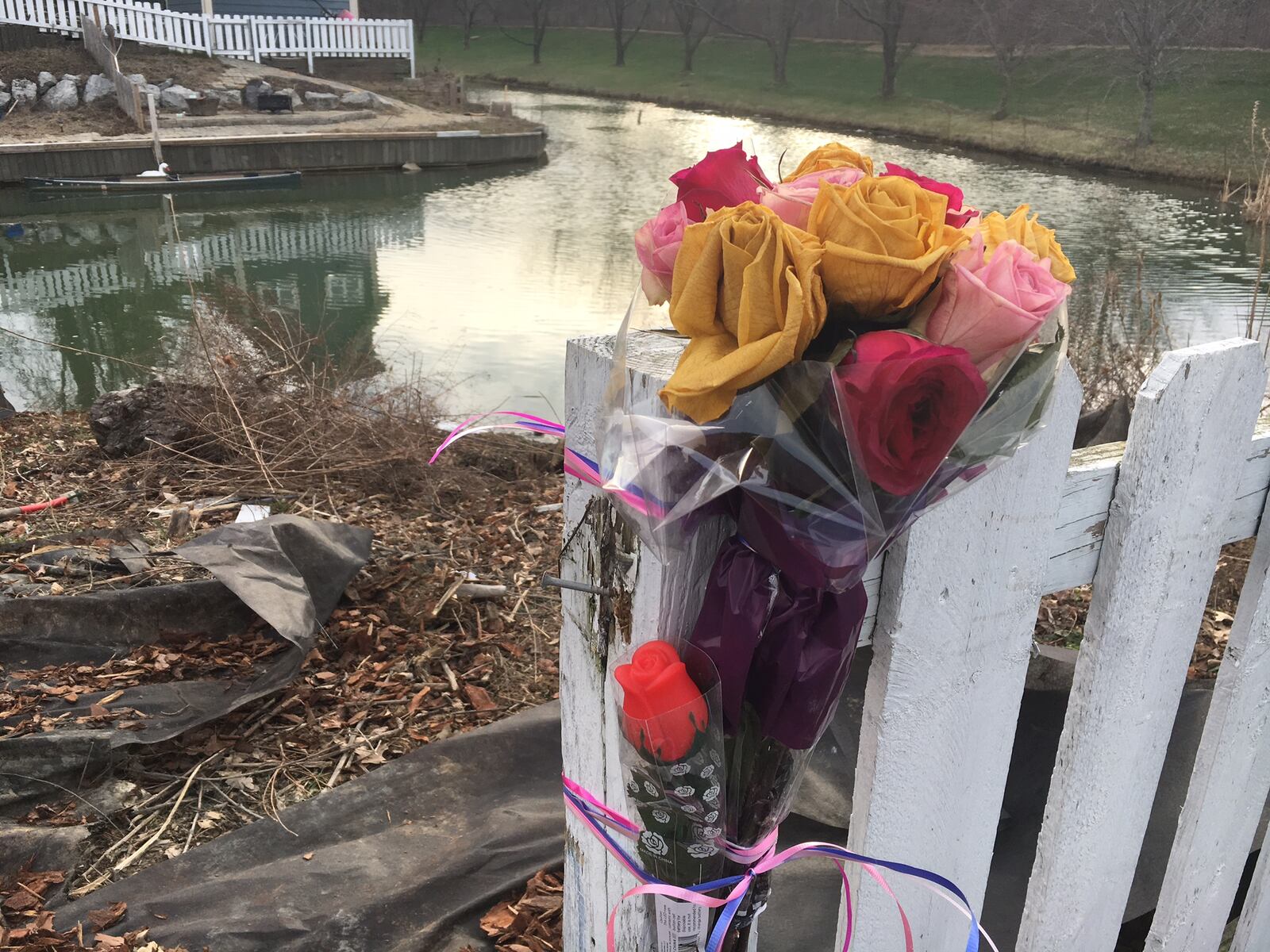 Flowers and stuffed animals have been left near a pond in Sugarcreek Twp. where Samantha Botts was killed when her car became submerged. CHUCK HAMLIN/STAFF