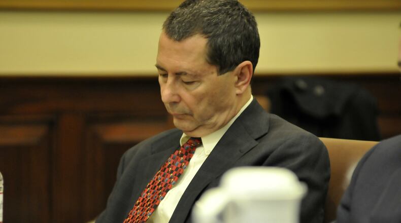 Pete Beck takes notes at the defense table during testimony of a witness on Friday, April 24, 2015, during his criminal trial in Hamilton County Common Pleas Court in downtown Cincinnati.
