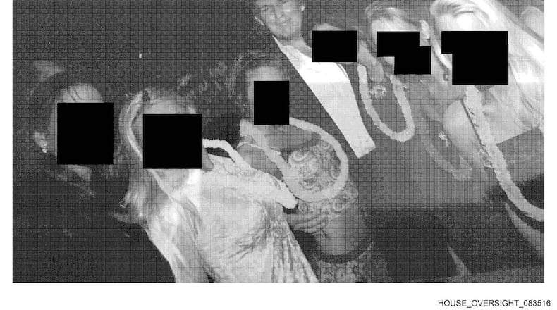 This undated, redacted photo released by Democrats on the House Oversight Committee shows Donald Trump standing with a group of women. (House Oversight Committee via AP)