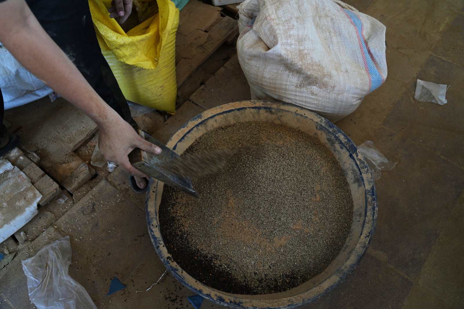 Displaced Palestinians purchase ground lentils as a substitute for making bread due to a shortage of flour in the Gaza Strip, in Khan Younis, on Sunday, May 11, 2025. (AP Photo/Abdel Karem Hanna)