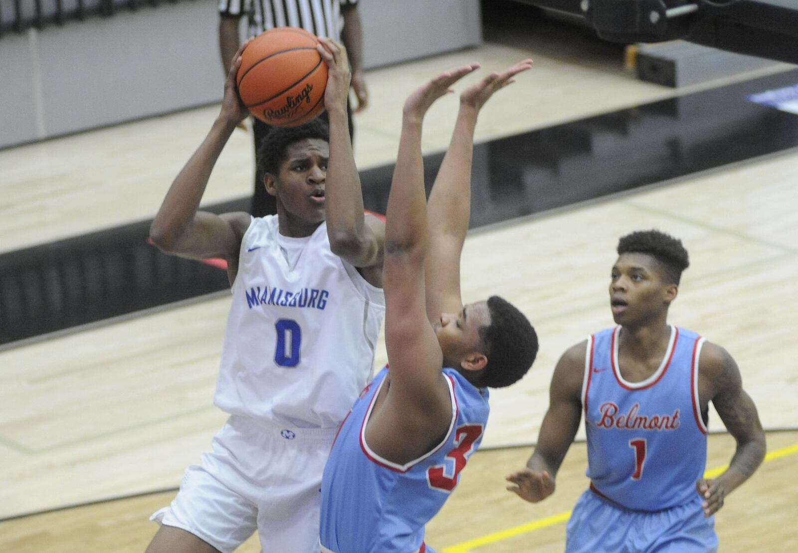 Miamisburg s Jason Hubbard works against Belmont s Latrell Estes (middle) and Jeff Hunt. Miamisburg defeated Belmont 71-59 in a boys D-I high school basketball sectional semi at Centerville on Tue., Feb. 28, 2018. MARC PENDLETON / STAFF