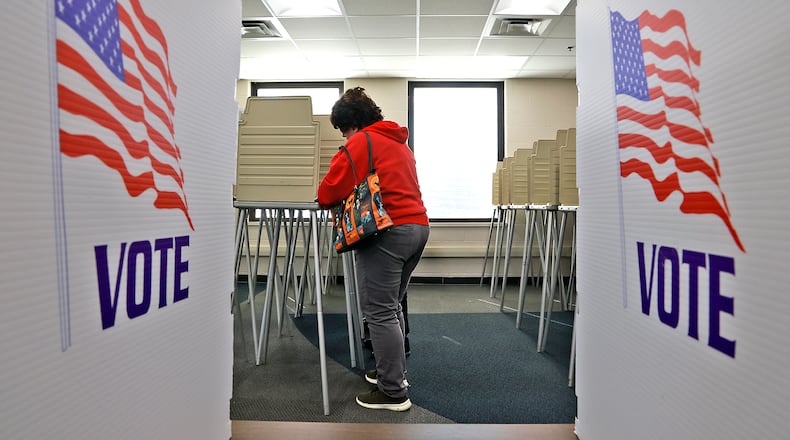 An early voter fills out their ballot Thursday, Oct. 17 at the Board of Elections. BILL LACKEY/STAFF