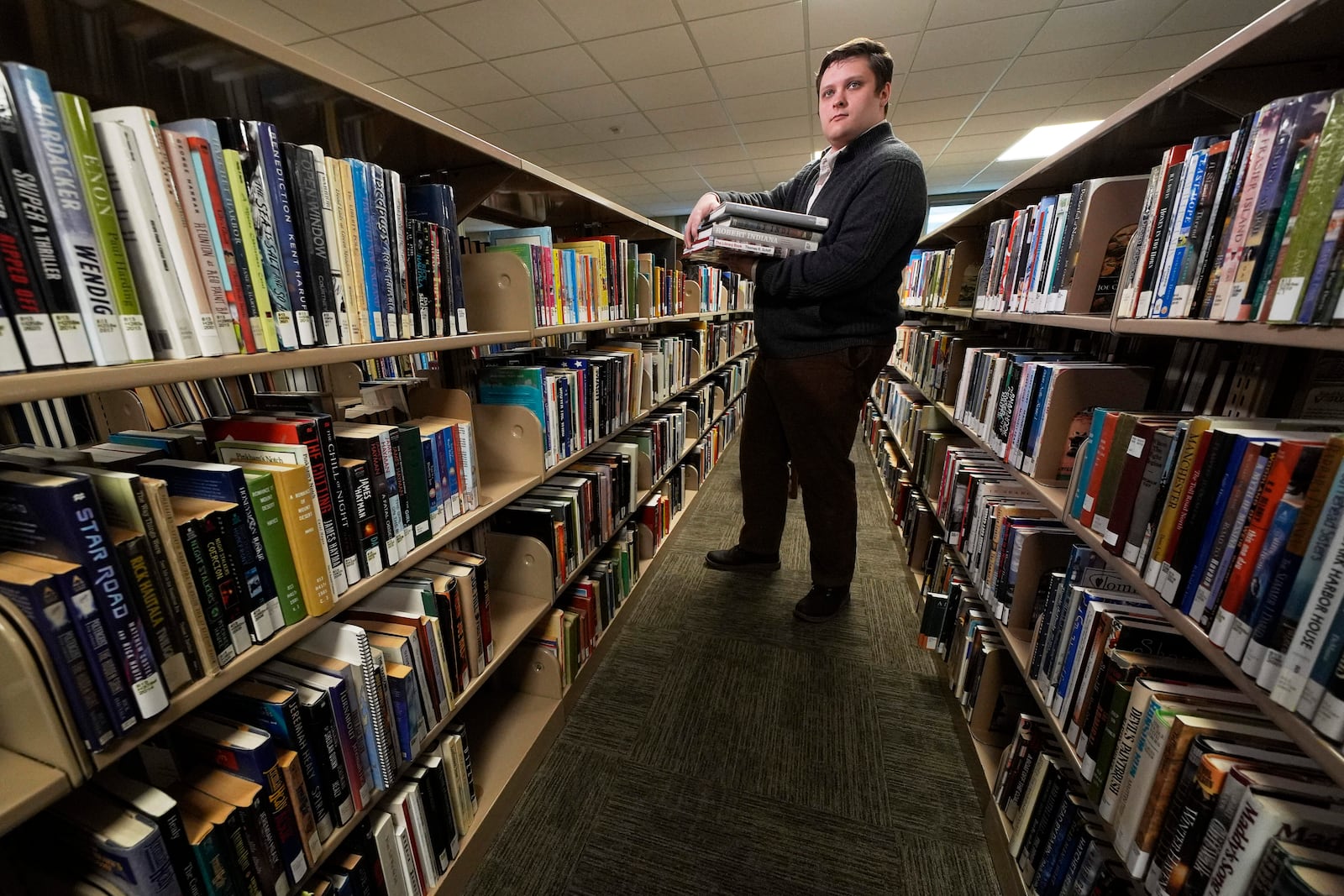 Spencer Davis, one of several librarians slated to be laid off due to DOGE cuts, works at the Maine State Library, Wednesday, May 7, 2025, in Augusta, Maine. (AP Photo/Robert F. Bukaty)