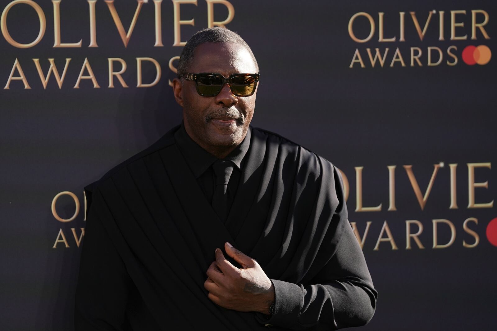 Idris Elba poses for photographers upon arrival at the Olivier Awards on Sunday, April 6, 2025, in London. (Photo by Alberto Pezzali/Invision/AP)