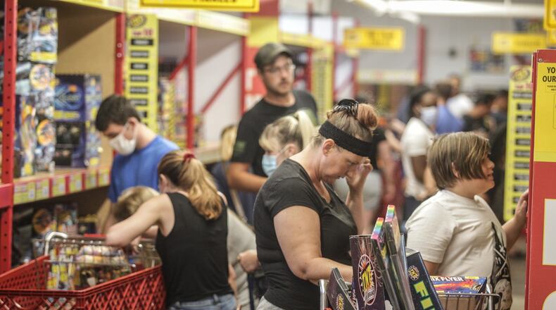 With Dayton canceling the annual Lights in Flight Fireworks Festival this weekend people packed the TNT Fireworks store on Union Road to make their own light show. Fireworks sales have been up lately according to fireworks shops. JIM NOELKER/STAFF