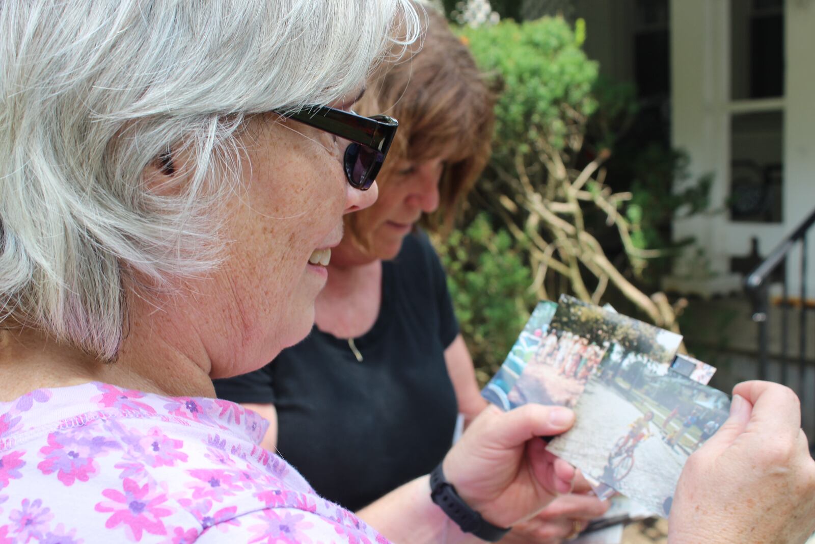 Dayton Wroe Avenue will celebrate the 50th anniversary of its  Labor Day weekend Block party on Sunday, Aug 3, 2017. Wroe Avenue residents Virginia Platt Gehres and Ann Szabo look at photos of past block parties. The women grew up on the street and now call it home.