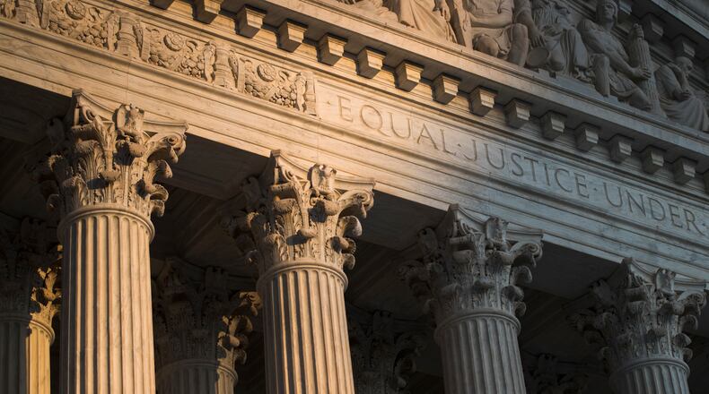 FILE - The Supreme Court in Washington is seen at sunset on Oct. 10, 2017. In a monthslong inquiry, which included reviewing tens of thousands of pages of documents from more than 100 public records requests, The Associated Press has examined what happens behind the scenes when Supreme Court justices travel to colleges and universities for lectures and other events. The AP learned the identities of donors and politicians invited to events with justices, details about the perks that have accompanied the school visits and information about how school trips have helped advance books sales. (AP Photo/J. Scott Applewhite, File)
