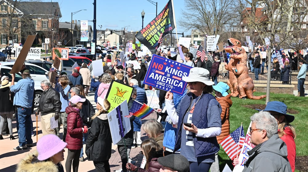 Hundreds of people participated in a "No Kings," protest on March 28 in and around the Miami County Courthouse plaza in downtown Troy. It was one of several protests scheduled to take place around the area Saturday. BRYANT BILLING / STAFF