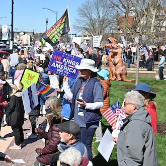 Hundreds of people participated in a "No Kings," protest on March 28 in and around the Miami County Courthouse plaza in downtown Troy. It was one of several protests scheduled to take place around the area Saturday. BRYANT BILLING / STAFF