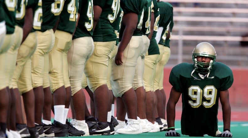 Colonel White's Bobby Martin walks behind temmates as they line up on the field prior to a  game vs. Dunbar. Photo by Jim Witmer