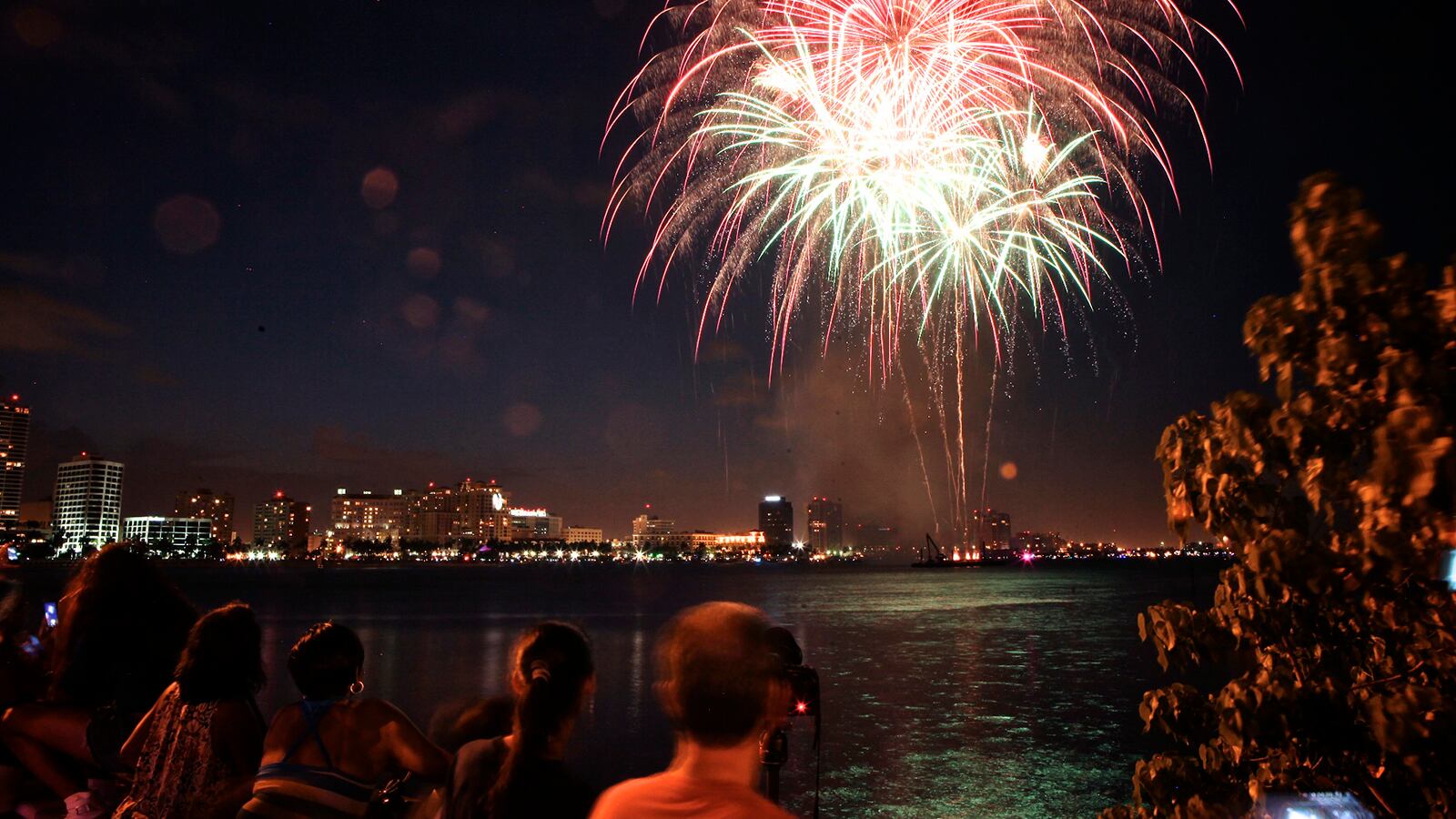 Perched on top of the Royal Park Bridge in West Palm Beach, residents and visitors enjoy a display of fireworks from  West Palm Beach's 4th on Flagler. (Palm Beach Post file photo)
